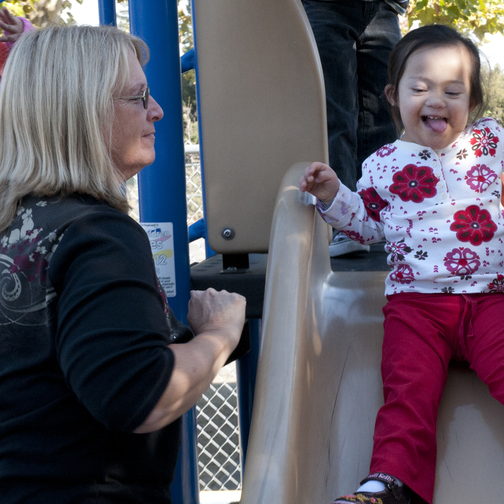 Child on slide with adult