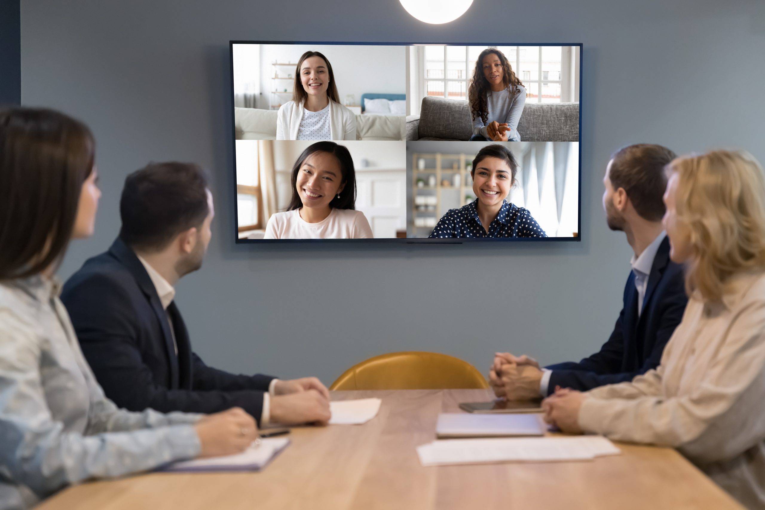 People sitting at a table with a computer.